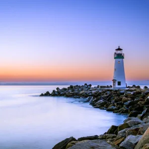 Lighthouse on a beach during sunset or sunrise